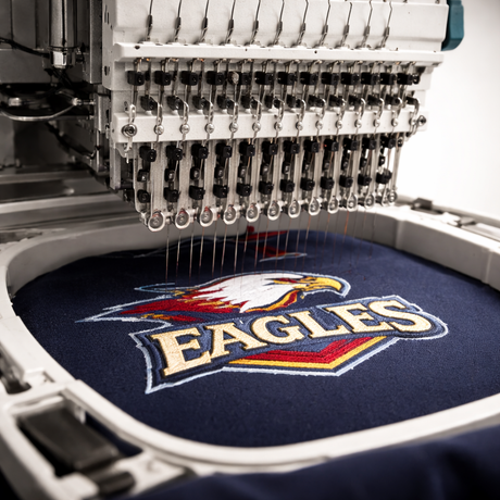 Commercial embroidery machine embroidering a logo
